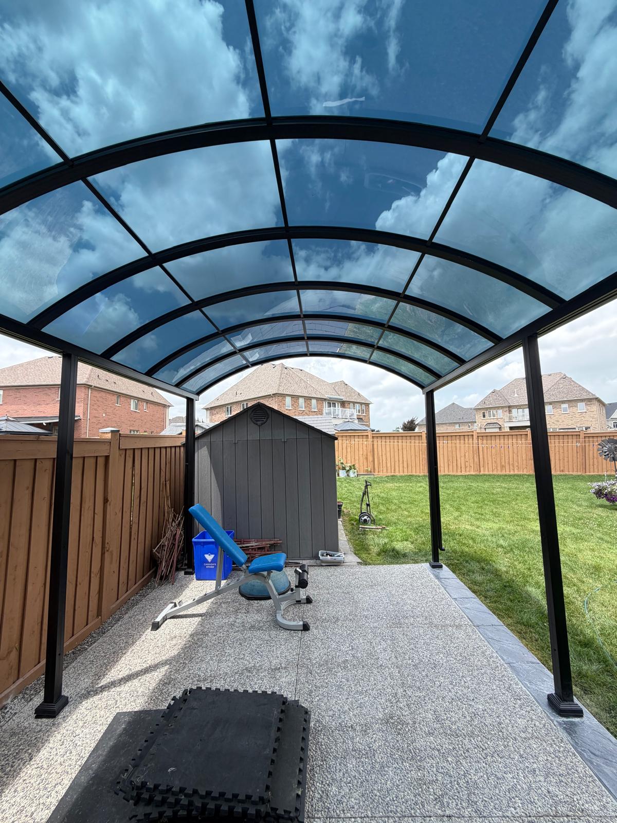 Arched dome polycarbonate roof over a backyard patio gym